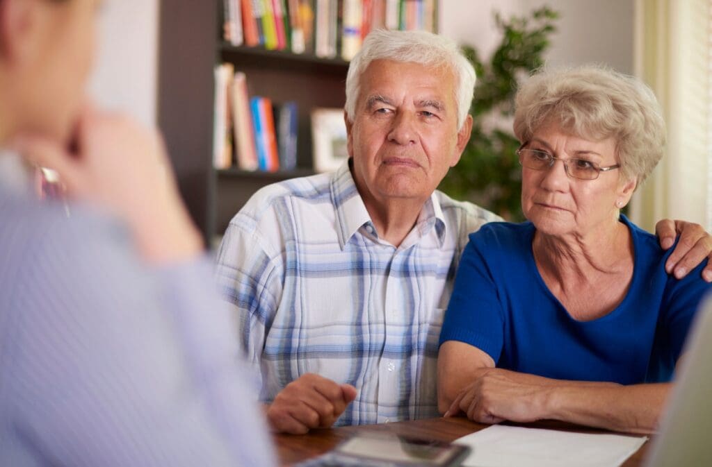 serious senior couple sitting office Protecting Your Future: Navigating Divorce and Retirement Savings